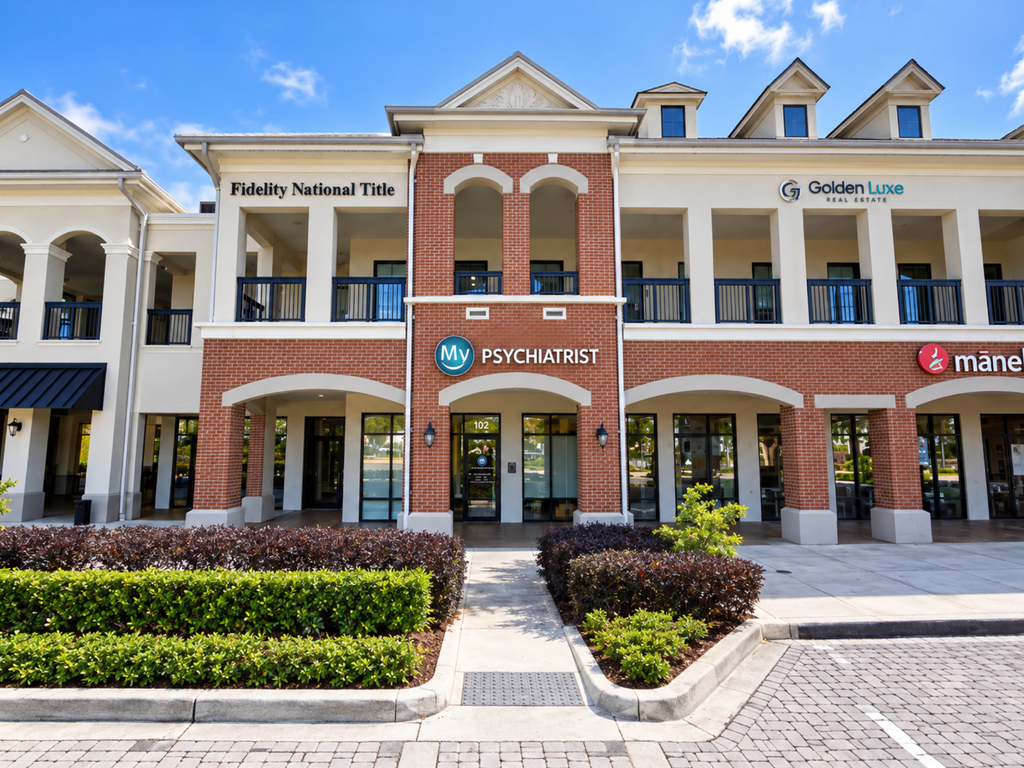 A modern brick and stucco office building with several business signs, including My Psychiatrist—your trusted psychiatrist in Orlando, FL—Fidelity National Title, and Golden Luxe Real Estate, with landscaping and parking in front.